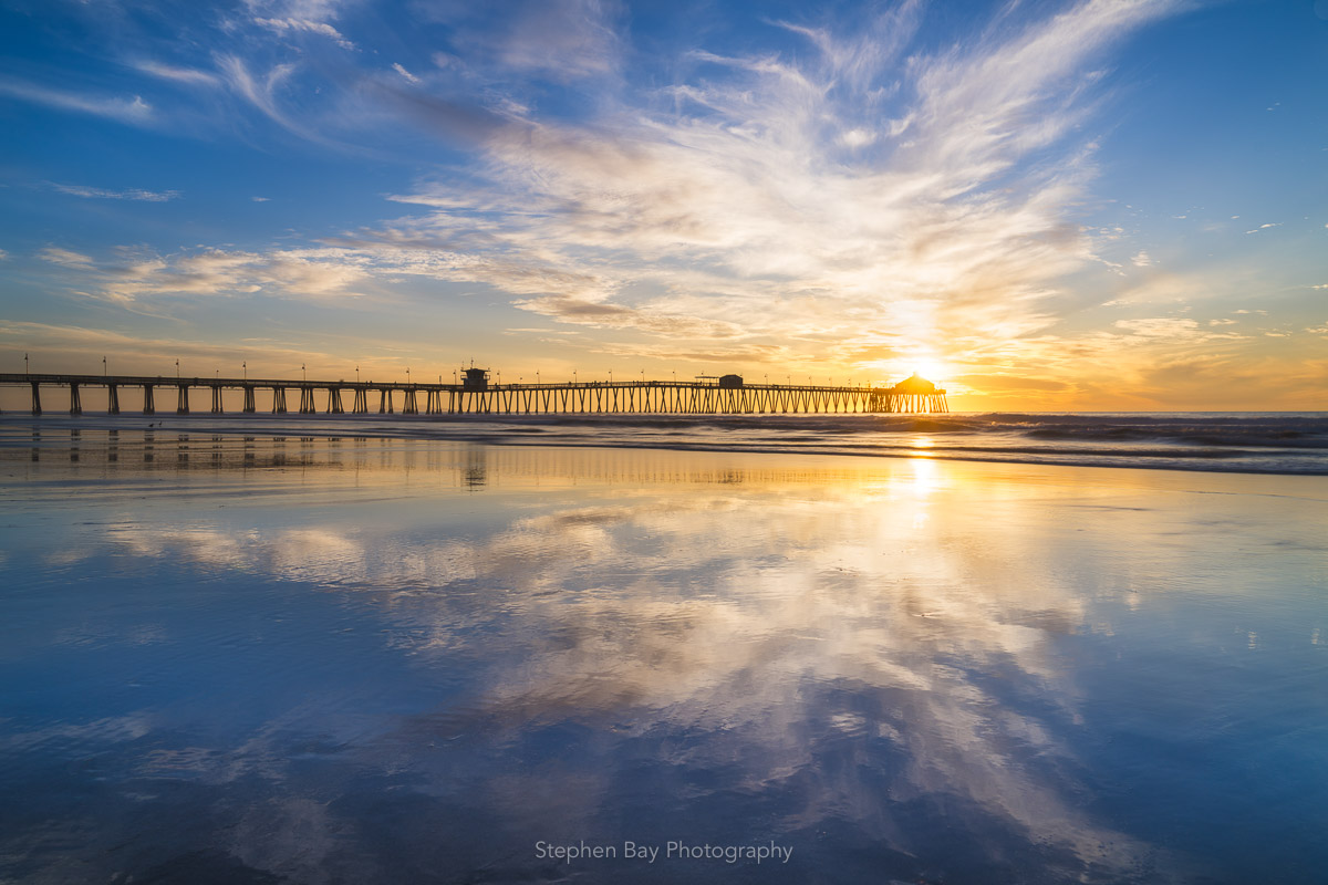 Clouds reflected in wet sand at Imperial Beach Pier