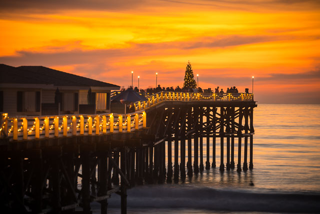 The Christmas tree at the end of the pier at Pacific Beach during a colorful sunset.