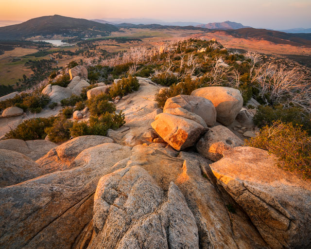 View from the top of Stonewall Peak in Rancho Cuyamaca State Park. The photo was taken at sunset and warm red glow covers the land.