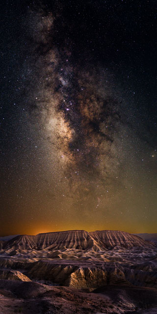 Elephant knees butte in Anza-Borrego desert state park with the Milky Way appears above in the night sky. This is a vertical panorama.
